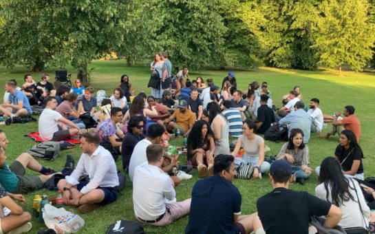 People sat having a picnic in a park