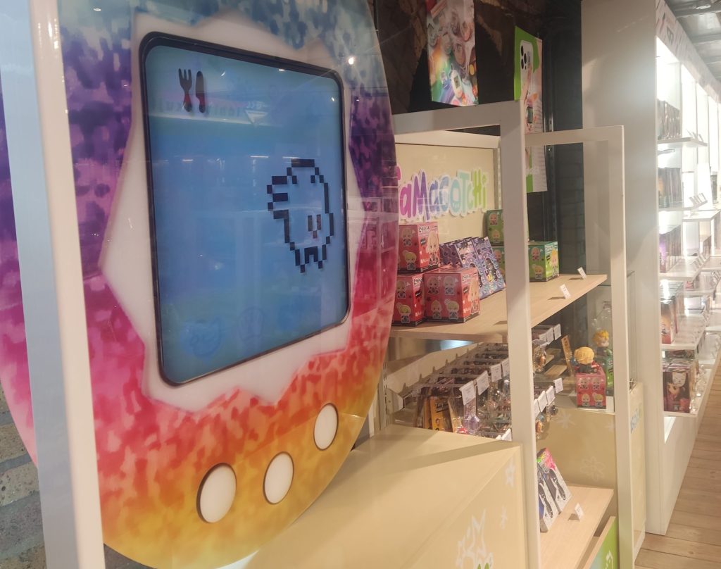 Part of a Tamagotchi display at the Bandai Namco Cross Store, depicting a large screen made to look like a Tamagotchi