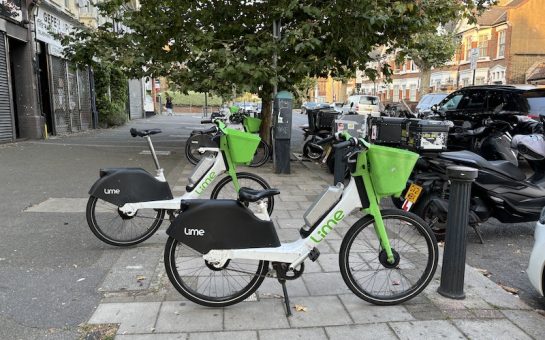 Lime bikes parked on pavement.