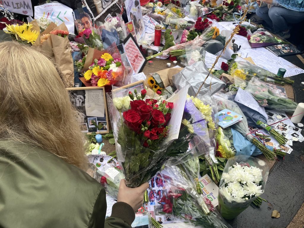 Payne's memorial covered with flowers, cards, candles and photos from fans.