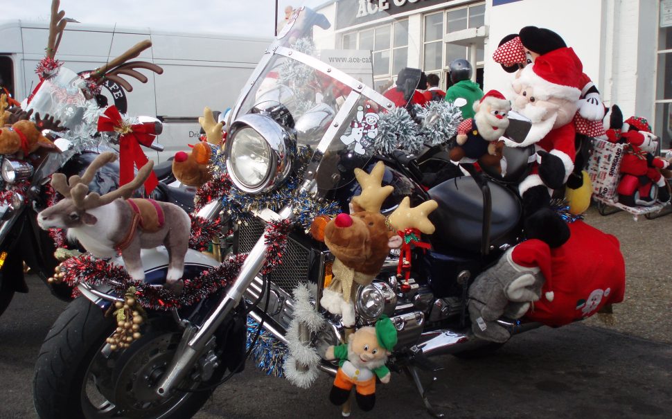 Ace Cafe volunteer Santa on decorated bike from toy run