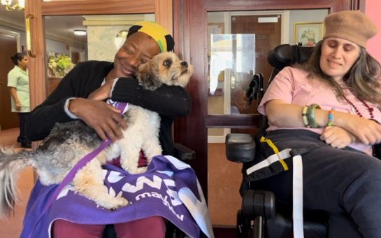 care home resident hugs dog