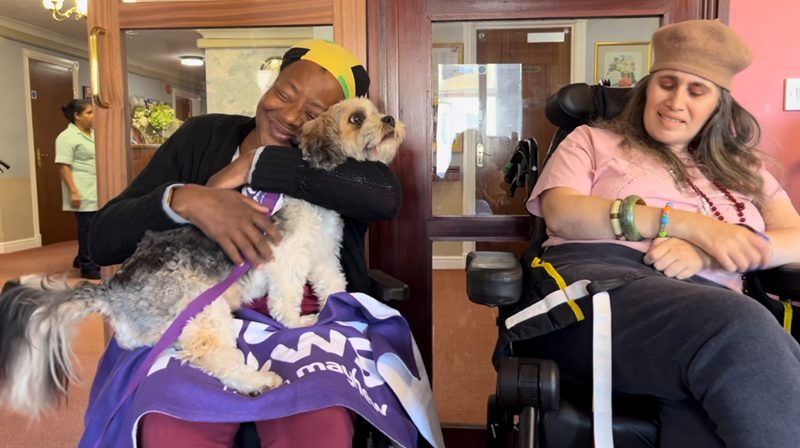 care home resident hugs dog