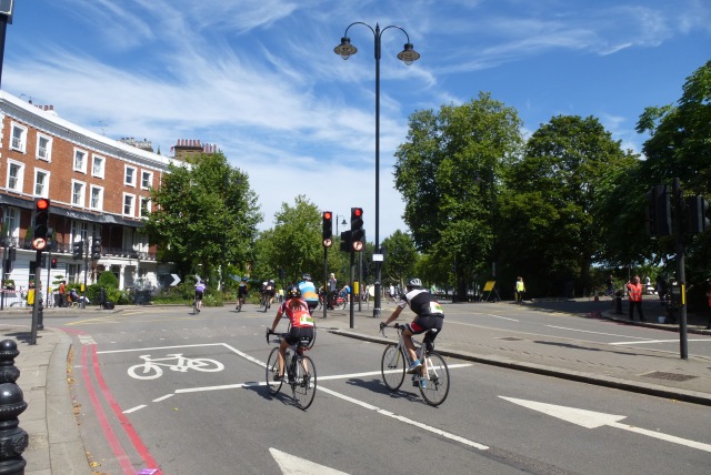 Two cyclists on their bikes by Chelsea Embankment